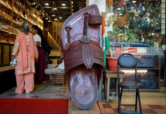 Customers shop for 'Kolhapuri' sandals, an Indian ethnic footwear, at a store in New Delhi, India, June 27, 2025. REUTERS/Adnan Abidi