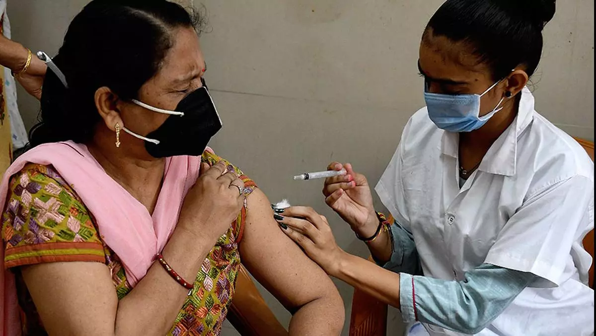  A woman gets her precaution dose of Covid-19 vaccine at UHC in Ahmedabad.