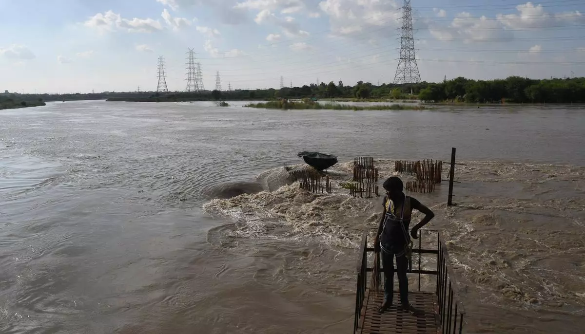The Yamuna seen flowing close to the danger level in Delhi on Friday after heavy rain in the upper catchment areas and release of water  from the Hathnikund barrage.  