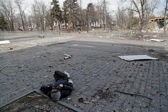 The body of a person killed during Ukraine-Russia conflict lies on the street in the southern port city of Mariupol Ukraine April 3, 2022. The body of a person killed during Ukraine-Russia conflict lies on the street in the southern port city of Mariupol Ukraine April 3, 2022.