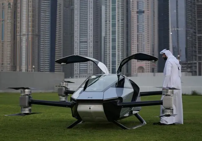 A man looks at the XPeng X2, an electric flying taxi developed by the Guangzhou-based XPeng, Inc’s aviation affiliate, being tested in front of the Marina District in Dubai, United Arab Emirates, Monday, Oct. 10, 2022. A man looks at the XPeng X2, an electric flying taxi developed by the Guangzhou-based XPeng, Inc’s aviation affiliate, being tested in front of the Marina District in Dubai, United Arab Emirates, Monday, Oct. 10, 2022.