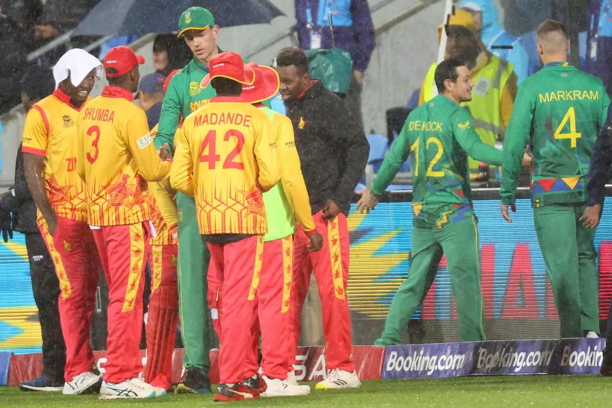 South Africa and Zimbabwe players shake hands after play was called off during the ICC men’s Twenty20 World Cup 2022 cricket match between South Africa and Zimbabwe at the Bellerive Oval in Hobart on October 24, 2022. 