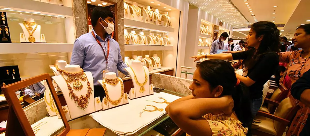 File Photo: Women buying gold ornaments at a jewellery showroom in Hyderabad on the occasions of Dhanteras and Diwali.