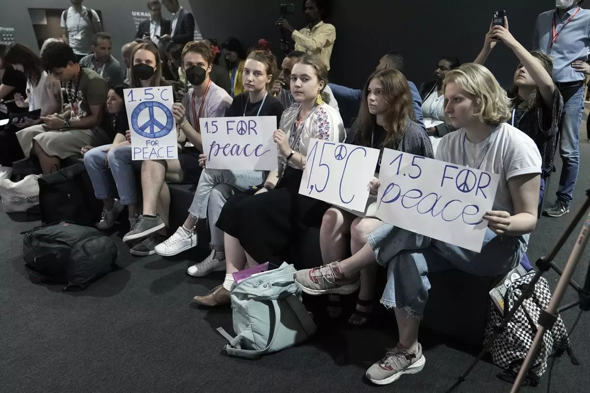 Activists hold signs for 1.5 for peace during a session with Center for Civil Liberties Oleksandra Matviychuk, of Ukraine, at the COP27 UN Climate Summit, on Thursday 