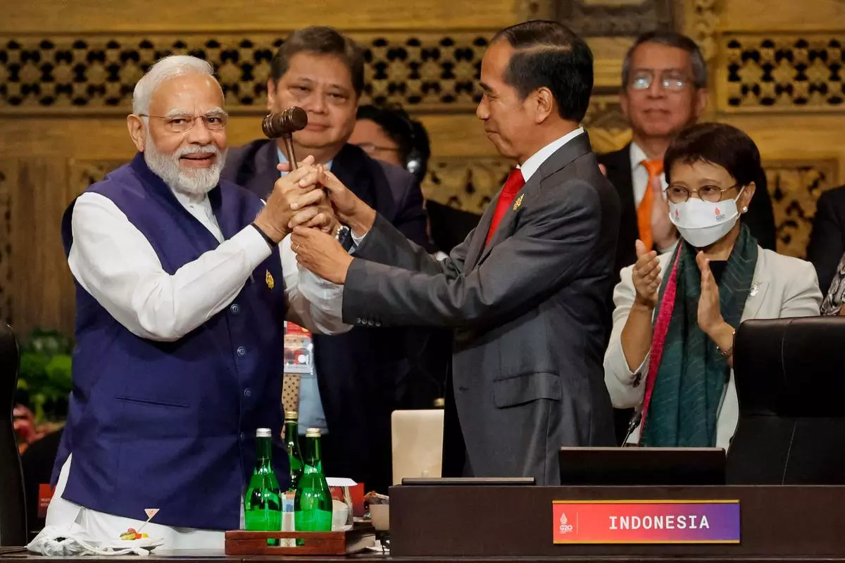 Prime Minister Narendra Modi and Indonesia’s President Joko Widodo take part in the handover ceremony during the G20 Summit in Nusa Dua on the Indonesian resort island of Bali on November 16 