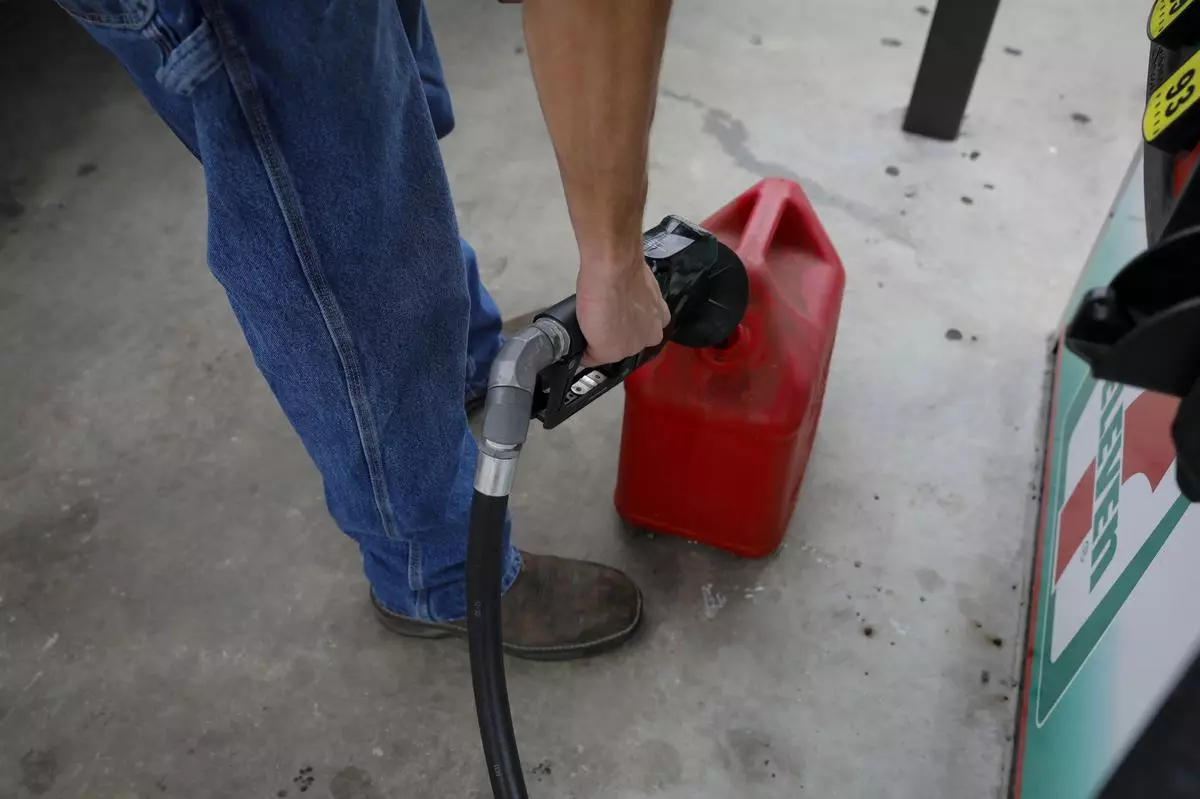 A customer fills canisters at a gas station ahead of Hurricane Ian in Tampa, Florida
