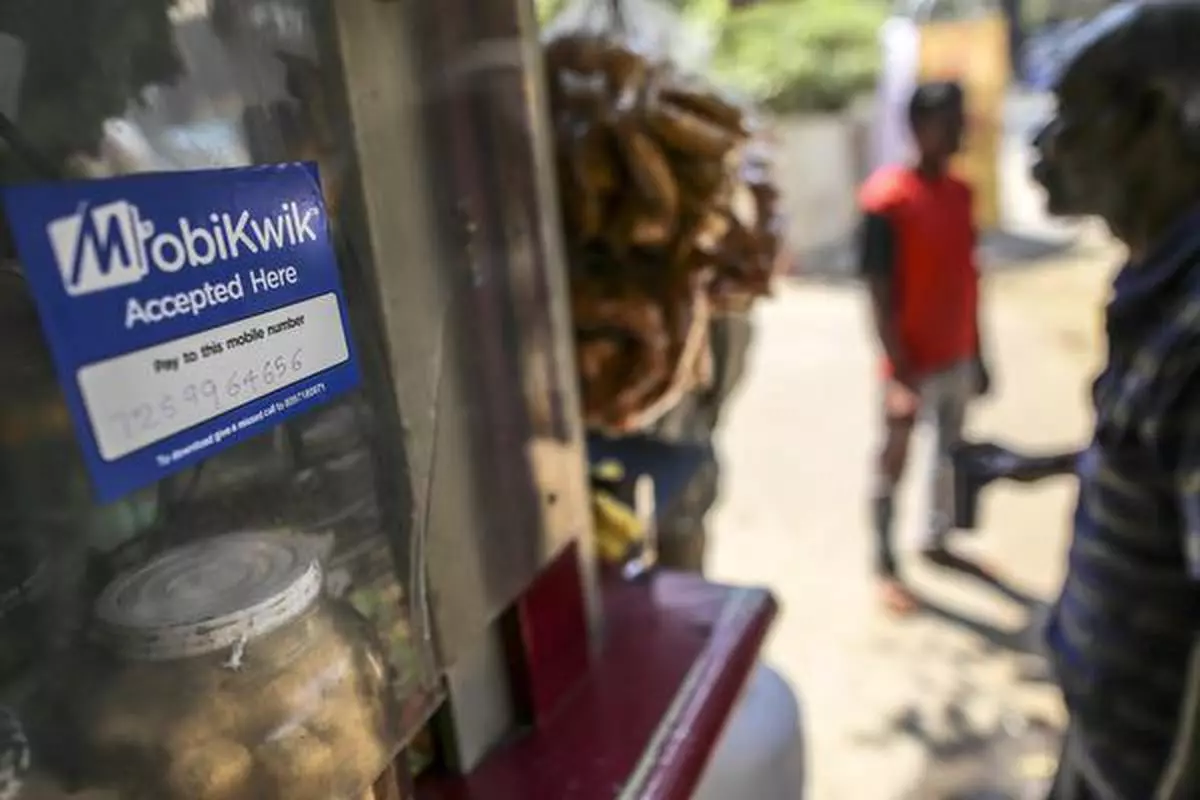 Signage for digital payment service MobiKwik, operated by One MobiKwik Systems Pvt., is displayed at a stall selling snacks in Bengaluru, India, on Saturday, Feb. 4, 2017. A relative laggard in digital transactions, India has more recently seen 50 percent year-on-year growth, according to a study by Google and Boston Consulting Group. The pace may accelerate with demonetization giving digital wallets like Paytm, MobiKwik and Freecharge an extra push. Photographer: Dhiraj Singh/Bloomberg