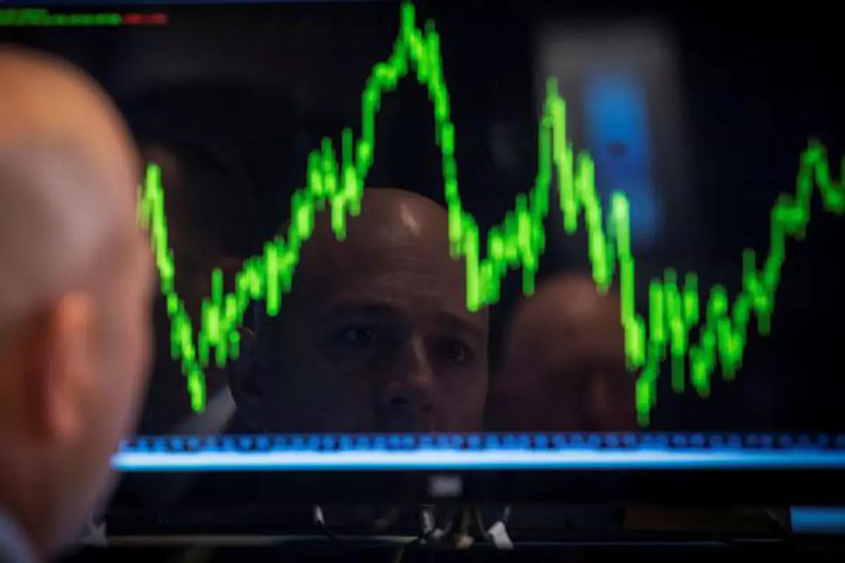 FILE PHOTO: A Specialist trader watches his chart while working on the floor of the New York Stock Exchange July 8, 2014. REUTERS/Brendan McDermid/File Photo