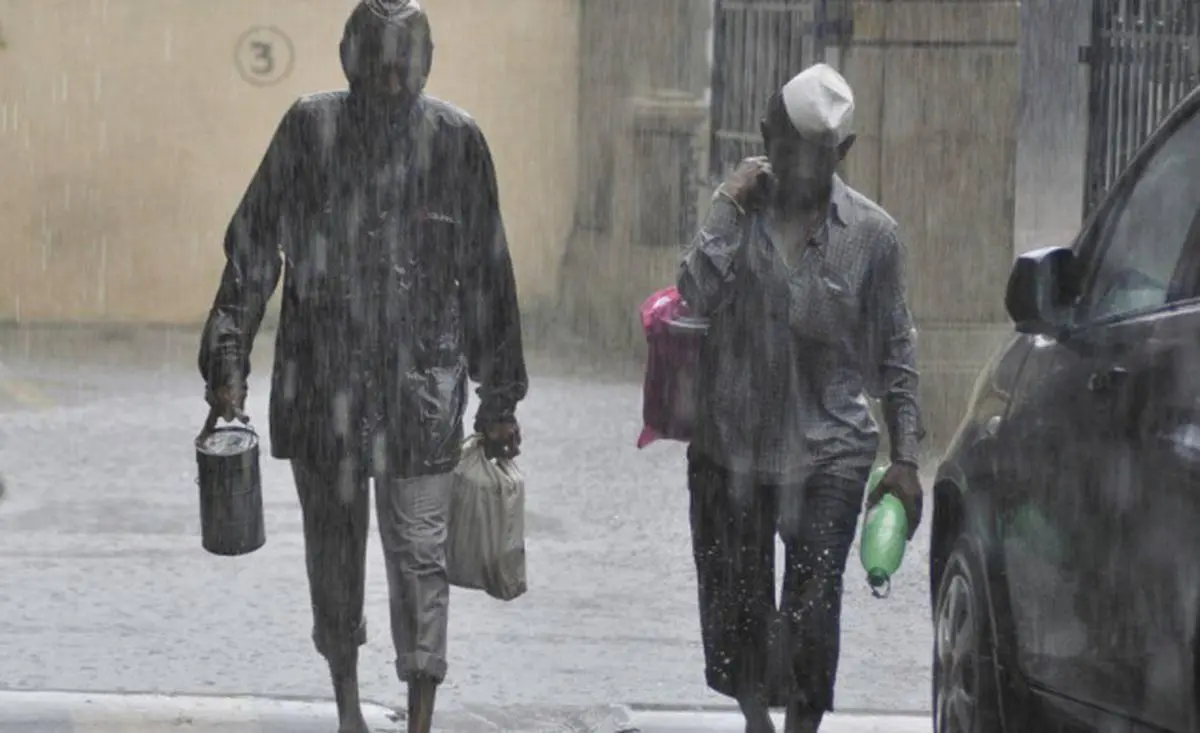 Mumbai's famous 'Dabbawalas' carrying lunch boxes to deliver home-cooked meals to office-goers in Mumbai even during heavy rains, in this recent file photo. -- Photo: Shashi Ashiwal