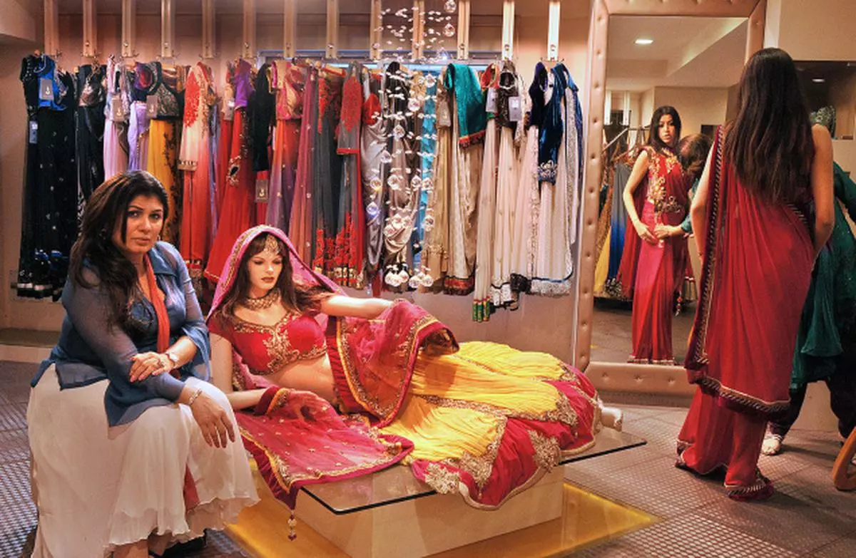 Festive buzz: Jaya Misra (left) posing with her festive collection at her boutique in Kolkata. — A. Roy Chowdhruy
