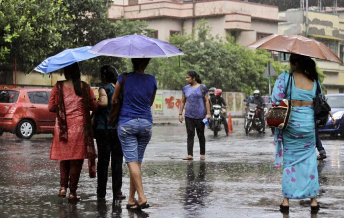 Indian commuters cross a road in