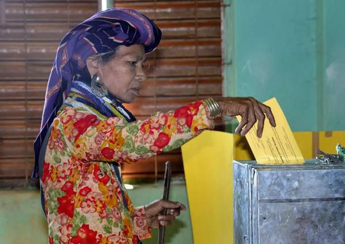 A Bru woman casts her vote in the Mizoram Assembly elections through postal ballot in Naisingpara Bru refugee camp in Tripura. The Bru community was displaced from Mizoram following ethnic conflicts with the Mizos in 1997 and since then they are sheltered in camps at Kanchanpur in north Tripura. Photo: Ritu Raj Konwar