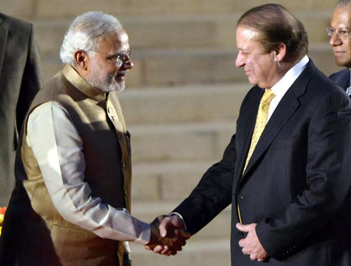 Warm ties Prime Minister Narendra Modi with his Pakistanicounterpart Nawaz Sharif at the swearing-in ceremony. RAJEEV BHATT