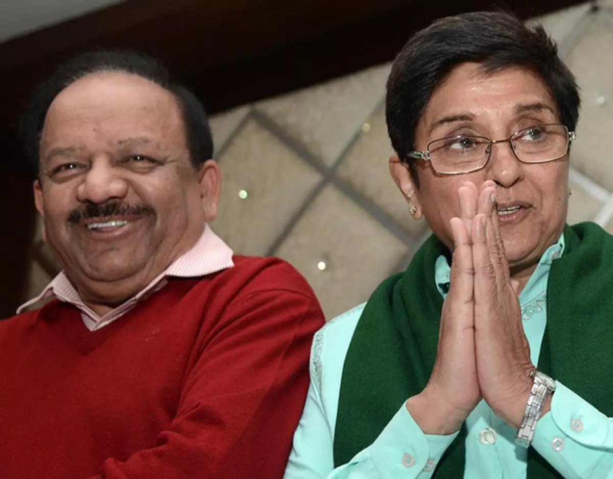 BJP leaders Harsh Vardhan and Kiran Bedi addressing party workers in New Delhi on Monday SANDEEP SAXENA