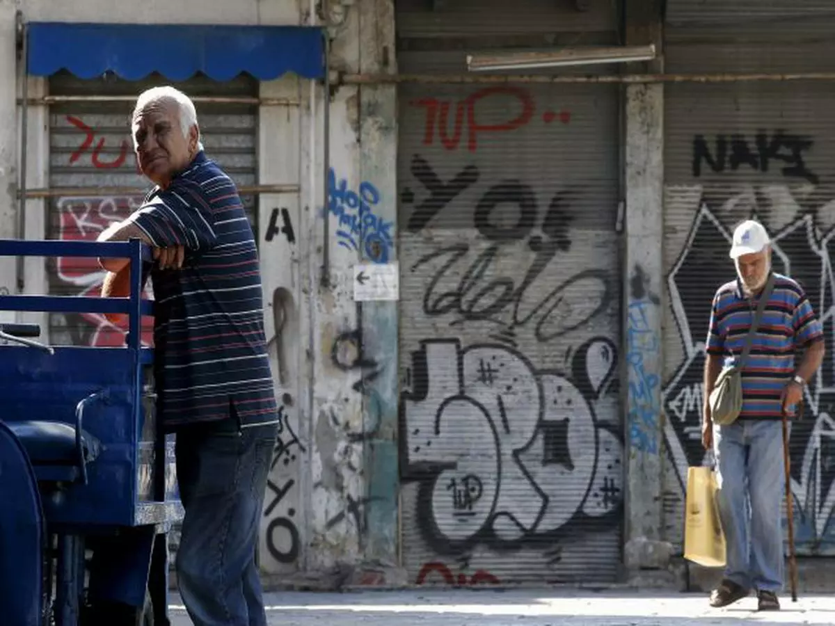 An elderly man leans on a delivery tricycle as he arrives to try to sell his used books to bookshops at Monastiraki area in central Athens, Greece, July 7, 2015. Greece faces a last chance to stay in the euro zone on Tuesday when Prime Minister Alexis Tsipras puts proposals to an emergency euro zone summit after Greek voters resoundingly rejected the austerity terms of a defunct bailout.