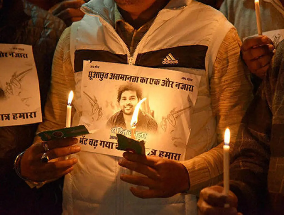 Activists holding a photo of  Rohit   Vemula  who committed suicide at Hyderabad Central University during a candle light march in  Bikaner.  PTI