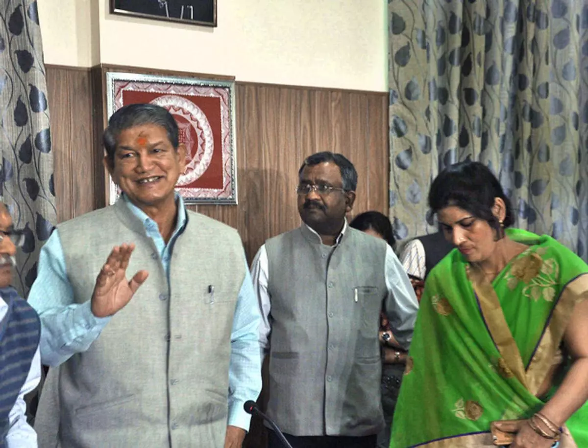 Up in arms Uttarakhand Chief Minister Harish Rawat with Congress MLA Mamta Rakesh addressing a press conference in Dehra Dun on Monday. Rawat accused the BJP-led Central government of “killing democracy” in the State VIRENDER SINGH NEGI