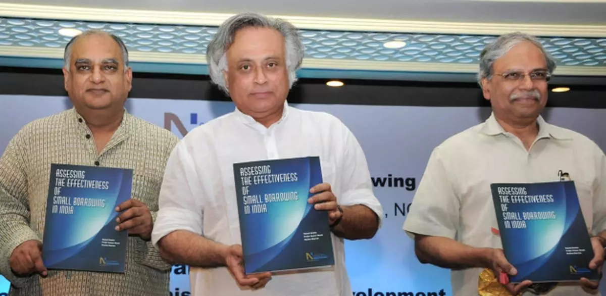 Mr Jairam Ramesh, Rural Development Minister, flanked by Mr Vijay Mahajan, President, Microfinance Institutions Network, and Mr Shekhar Shah (right), Director-General, National Council of Applied Economic Research, releasing the report on ‘Assessing the effectiveness of small borrowings’ in the Capital on Monday. — Kamal Narang