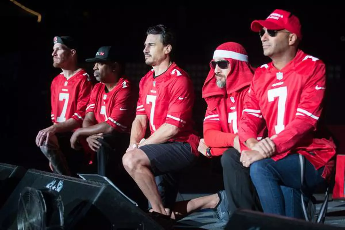 Grace in dissent: Prophets of Rage, an American rock band, wore San Francisco 49er Colin Kaepernick jerseys and took a knee, following a trend Kaepernick kicked off, while the national anthem played before their show in 2016.