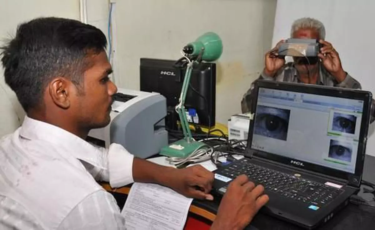 A man registering his identity with iris scanning on a digital machine for obtaining &quot;Aadhaar&quot; during the Proof of Concept phase of the Unique Identification Authority of India Project