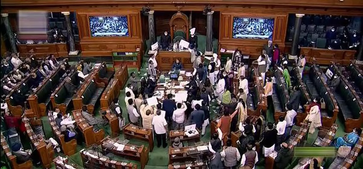 Opposition MPs protest in the Lok Sabha during the Winter Session of Parliament, in New Delhi.