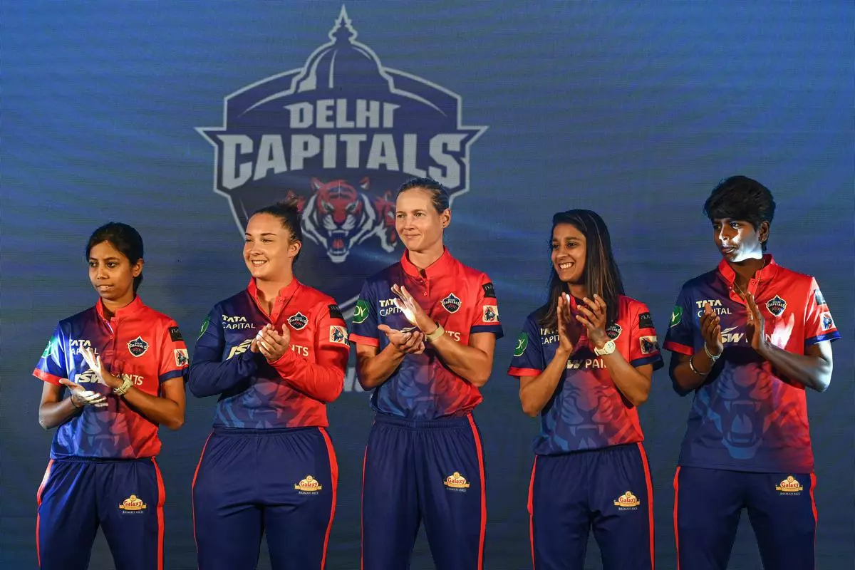 (L-R) Delhi Capitals cricketers Aparna Mondal, Alice Capsey, Meg Lanning, Jemimah Rodrigues and Minnu Mani applaud their teammates during a press conference ahead of the inaugural Women’s Premier League (WPL), in Mumbai 