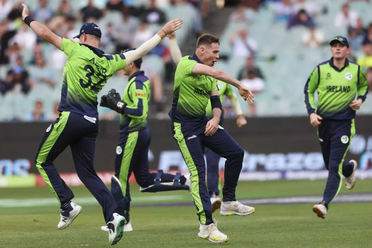 Ireland‘s Josh Little, centre, celebrates with teammate Mark Adair, left, after dismissing England’s Jos Buttler during the T20 World Cup cricket match between England and Ireland in Melbourne, Australia, Wednesday, October 26, 2022. (AP/PTI)