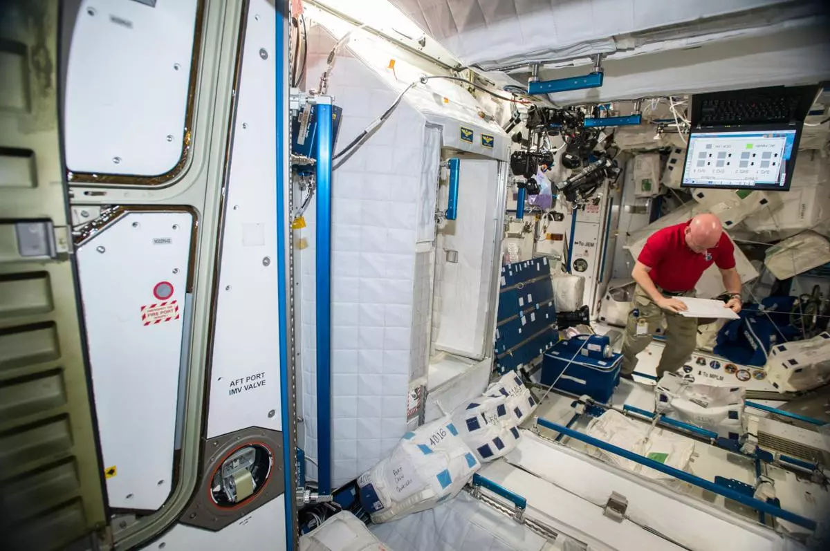 NASA astronaut Scott Kelly collecting surface & air samples using various devices in multiple locations to characterize types of microbial populations on ISS 