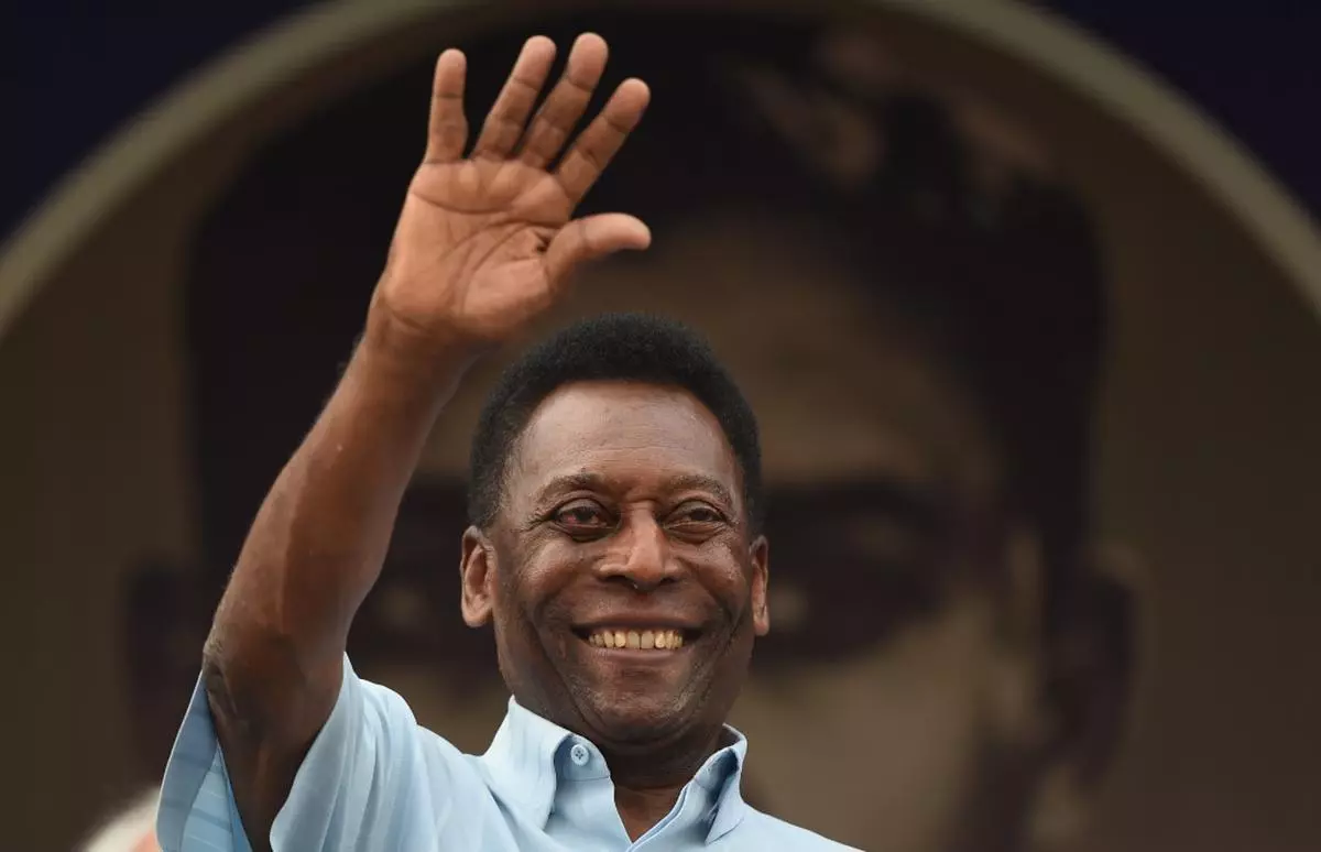 In this file photo taken on October 16, 2015, former Brazilian footballer Pele waves to the crowd before the start of the Under-17 boys final match of the Subroto Cup in New Delhi