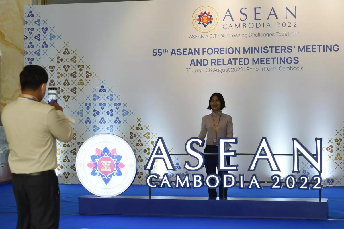 Staff members take picture in front of ASEAN logo at a hotel where the 55th ASEAN Foreign Ministers’ Meeting (55th AMM) is taking place in Phnom Penh, Cambodia, Tuesday, August 2, 2022