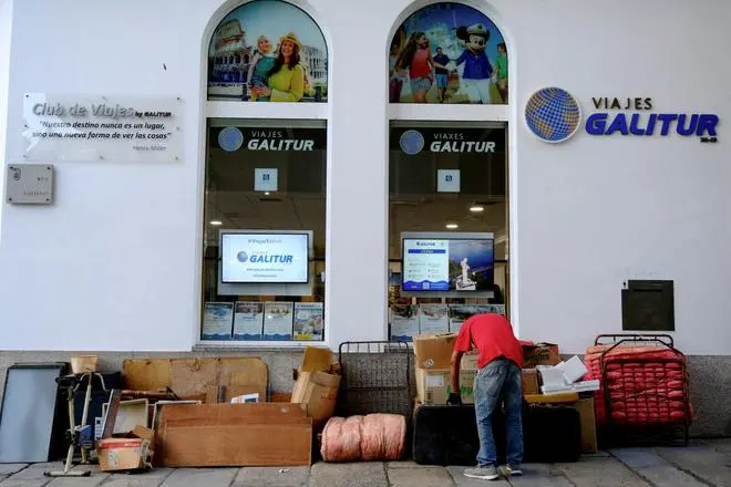 A man places belongings next to a wall on a street in front of a travel agency shop in Ferrol, northernwestern Spain, September 6, 2022. REUTERS A man places belongings next to a wall on a street in front of a travel agency shop in Ferrol, northernwestern Spain, September 6, 2022. REUTERS
