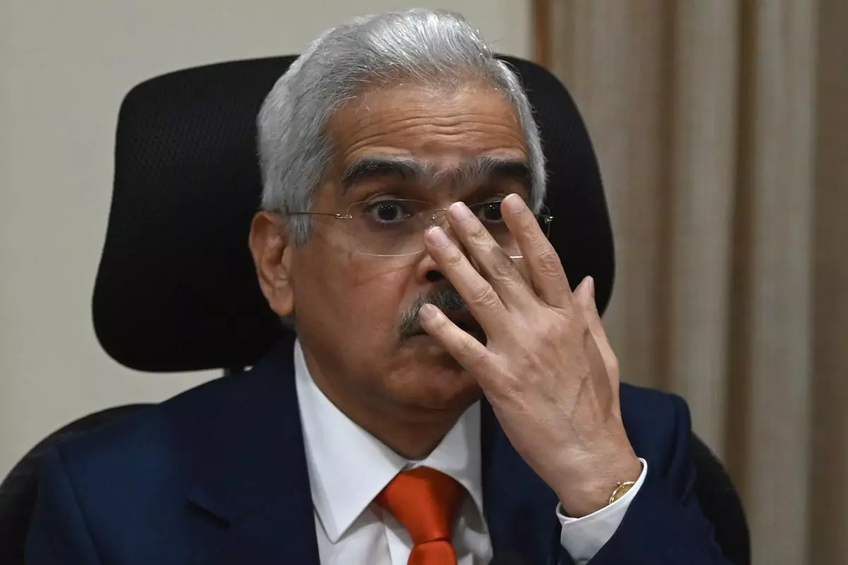 Reserve Bank of India Governor Shaktikanta Das gestures as he speaks during a press conference at the RBI head office in Mumbai on September 30, 2022. (Photo by Punit PARANJPE / AFP)