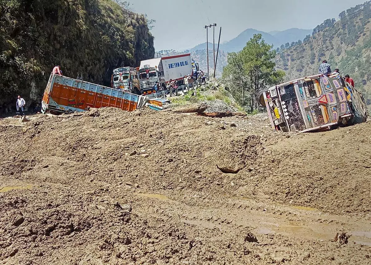 FILE PHOTO: Trucks are stranded as the Srinagar-Jammu National Highway was blocked after a landslide due to rains, in the Banihal sector, Thursday, June 23, 2022. (PTI Photo)