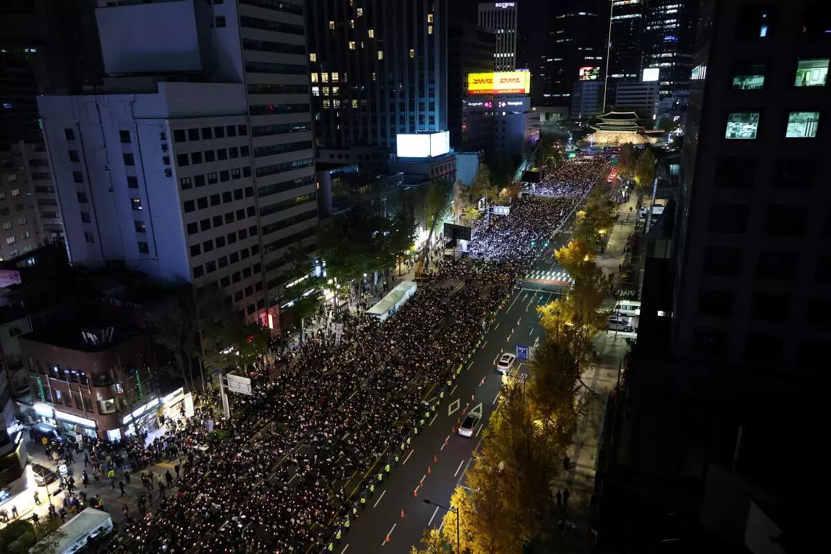 People attend a candlelight vigil to commemorate the victims of the crowd crush that happened during Halloween festivities, at Seoul City Hall Plaza, in Seoul, South Korea, November 5, 2022. REUTERS