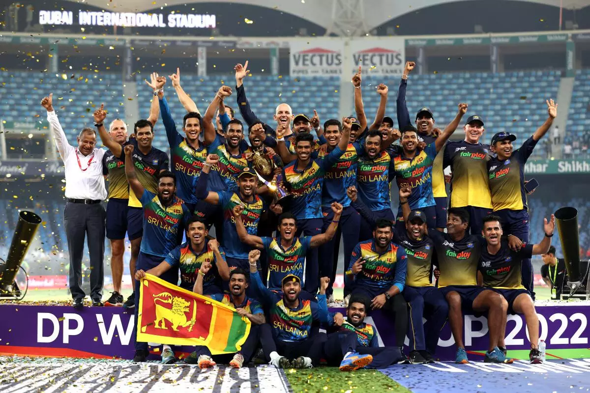 Sri Lanka players celebrate with the trophy after winning the Asia Cup. REUTERS