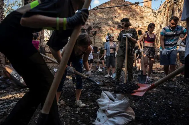 Volunteers clean up the House of a Culture in the village of Yahidne, which was heavily damaged during Russia’s attack on Ukraine, in Chernihiv region, Ukraine July 23, 2022. Members of the volunteers’ movement Repair Together travel over regions, which were under Russian occupation and help local residents to clean up damaged buildings under accompaniment of electronic music. REUTERS Volunteers clean up the House of a Culture in the village of Yahidne, which was heavily damaged during Russia’s attack on Ukraine, in Chernihiv region, Ukraine July 23, 2022. Members of the volunteers’ movement Repair Together travel over regions, which were under Russian occupation and help local residents to clean up damaged buildings under accompaniment of electronic music. REUTERS