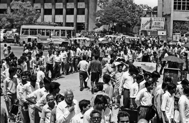 File photo of stock market investors in a long queue in front of bank counters with share applications and deposits at Parliament street in New Delhi on May 08, 1992. (Source: The Hindu Archives) File photo of stock market investors in a long queue in front of bank counters with share applications and deposits at Parliament street in New Delhi on May 08, 1992. (Source: The Hindu Archives)