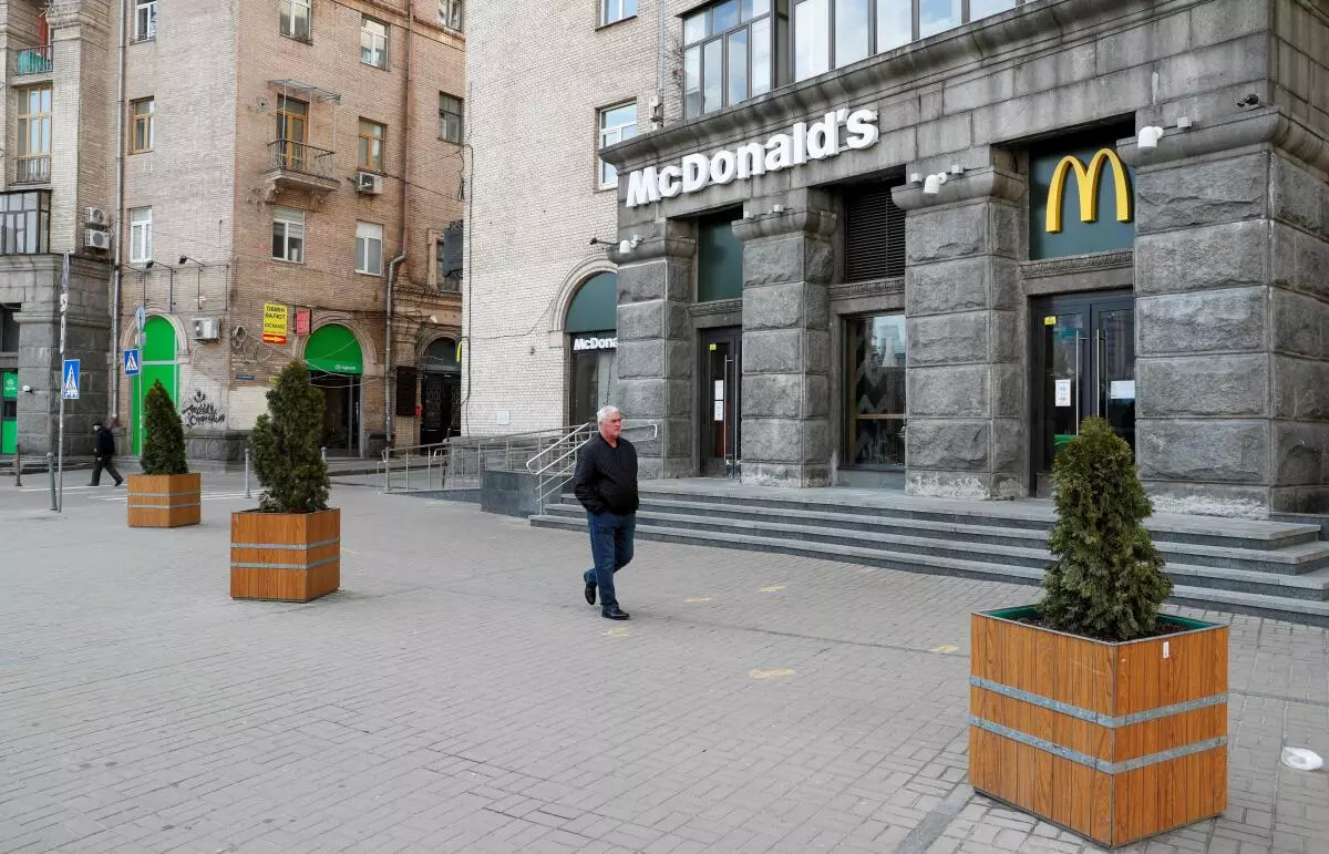 FILE PHOTO: A man walks past a closed McDonald‘s restaurant in central Kyiv, Ukraine February 25, 2022. REUTERS