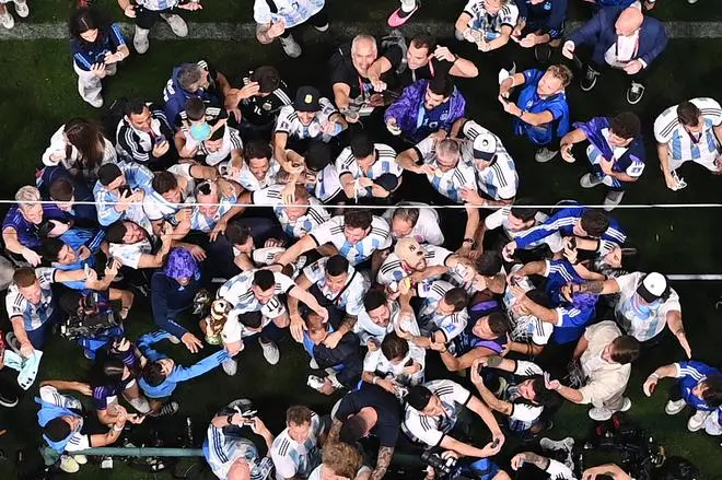 Argentina's forward #10 Lionel Messi is carried on the shoulders of fans after the Qatar 2022 World Cup Final football match between Argentina and France at Lusail Stadium in Lusail, north of Doha.