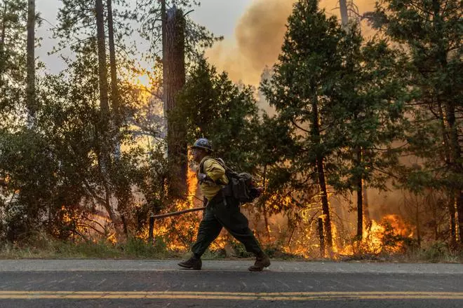 A firefighter works to extinguish the Oak Fire as it burns near Darrah in Mariposa County, California, US, July 23, 2022. REUTERS