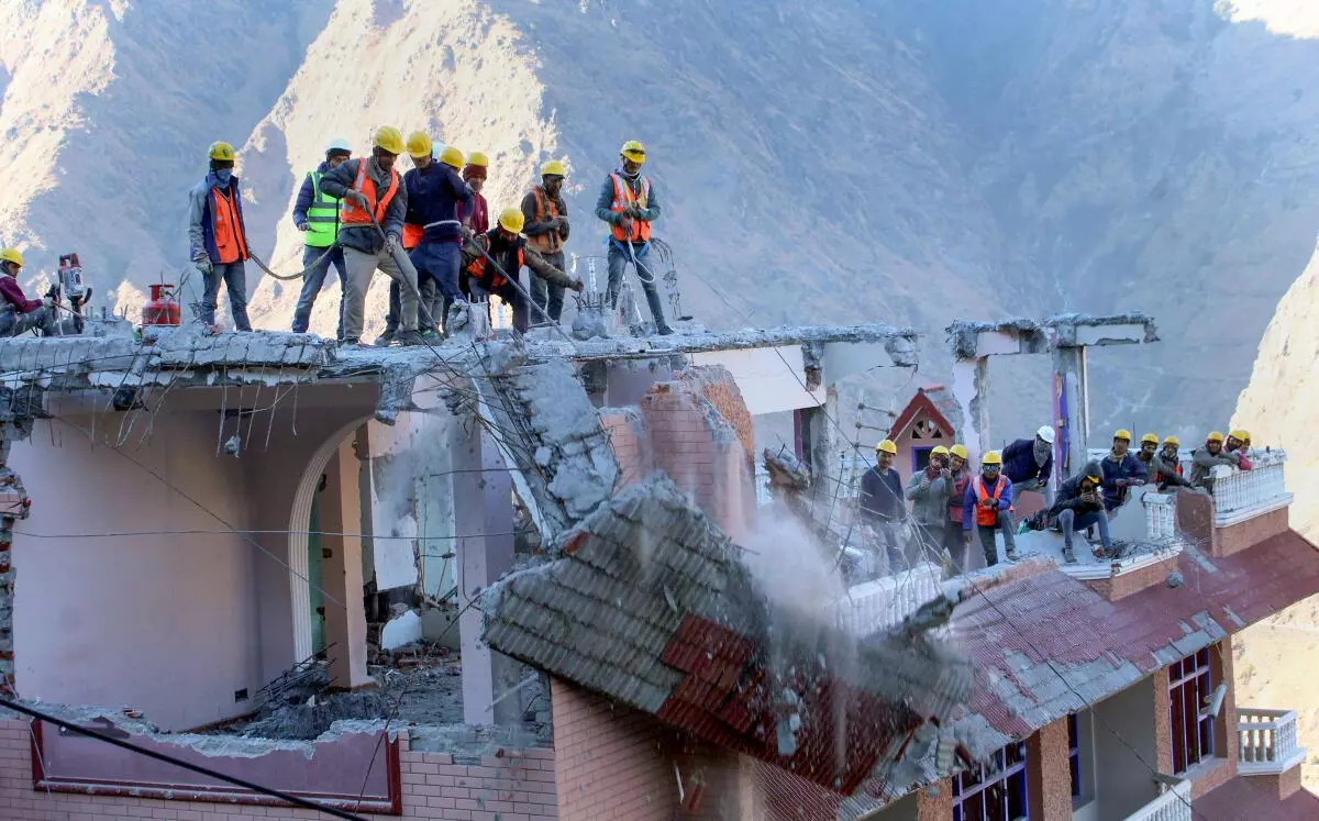 SDRF personnel demolish the Malari Inn hotel, which was marked unsafe in the land subsidence affected area, in Joshimath, Saturday, January 28, 2023. (PTI Photo)