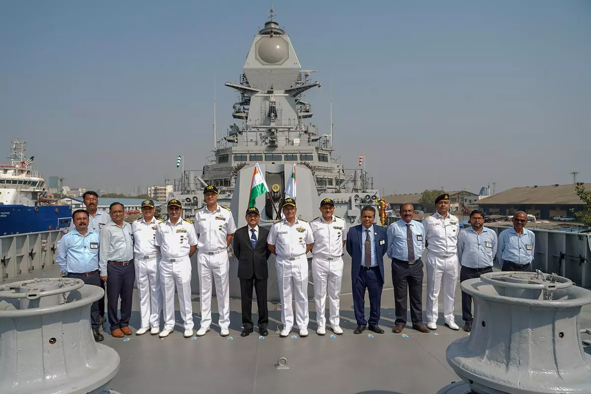 Navy officials pose on the deck of Y 12705 (Mormugao), the second ship of Project 15B stealth guided missile destroyers being built at Mazagon Dock Shipbuilders Limited (MDL) in Mormugao.