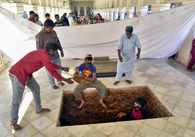 Workers make a grave where Prince Mukarram Jah will be laid to rest at Mecca Masjid, in Hyderabad, Monday, January 16, 2023. (PTI Photo)