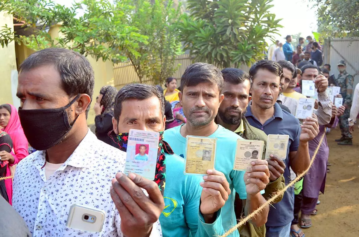 People wait to cast their votes at a polling station during municipal corporations elections in Agartala. (PTI)