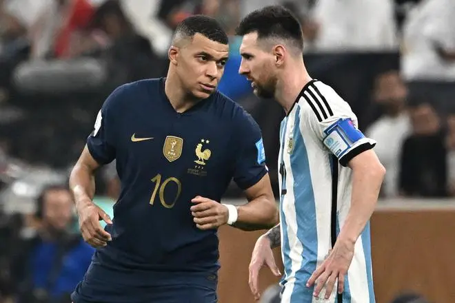 France forward #10 Kylian Mbappe (L) points to Argentina forward #10 Lionel Messi (R) during the Qatar 2022 World Cup Final football match between Argentina and France at Lusail Stadium.