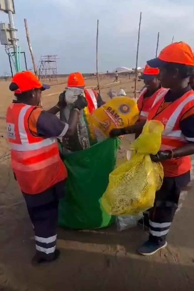 Workers busy collecting the trash at the Marina Beach