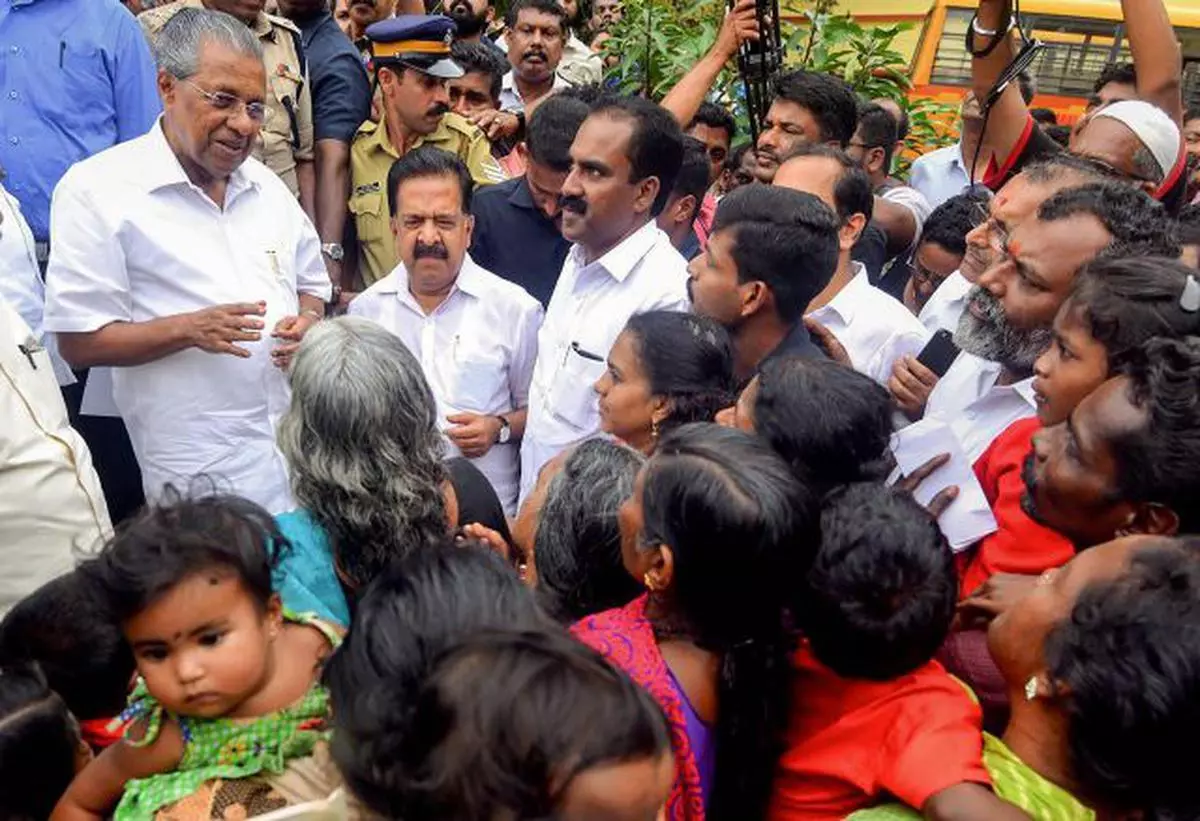 Kerala Chief Minister Pinarayi Vijayan interacts with the flood-affected people at a relief camp in Ernakulam on Saturday, August 11, 2018. 
