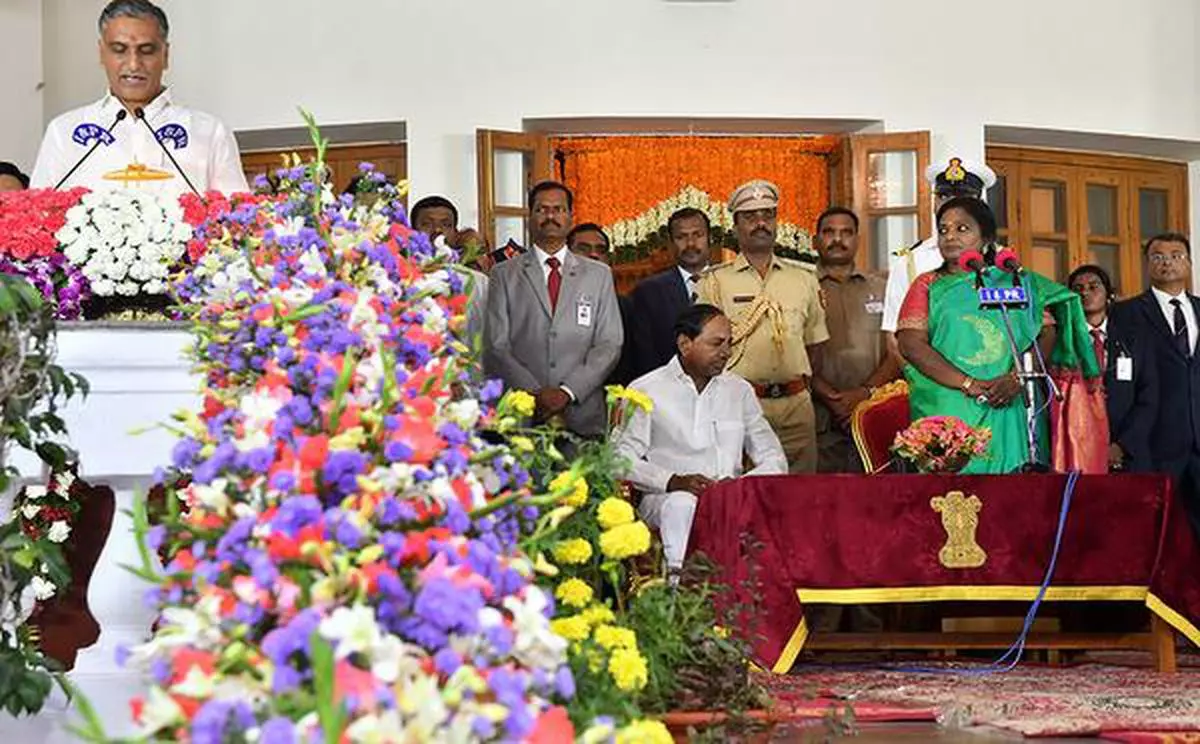 The newly sworn-in Minister in the Telangana Cabinet T Harish Rao taking oath in the presence Chief Minister K Chandrasekhar Rao and Governor Tamilisai Soundararajan, in Hyderabad, on Sunday
