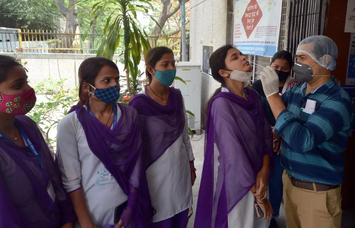 Health worker collecting swab sample for conducting Covid 19 RTPCR Test at the Daryagang Dispensary in New Delhi on Wednesday, April 20, 2022. The number of Covid positive cases are increasing in the Capital. 