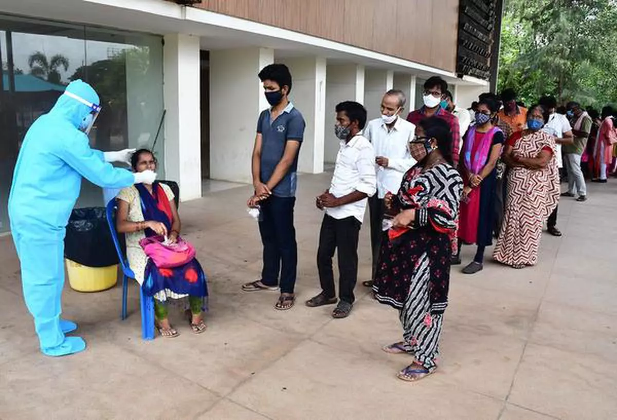 ANDHRA PRADESH, VIJAYAWADA, 10-06-2021: A health technician collecting sample from a woman for COVID test at COVID testing centre at Tummalapalli Kalakshetram in Vijayawada on Thursday. Photo: GIRI KVS/ The Hindu